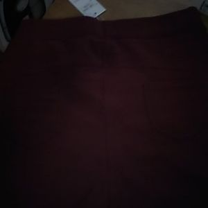 Burgundy pants with black design on front